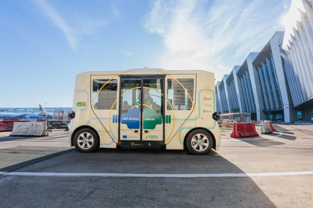 An autonomous electric shuttle bus at an airport.